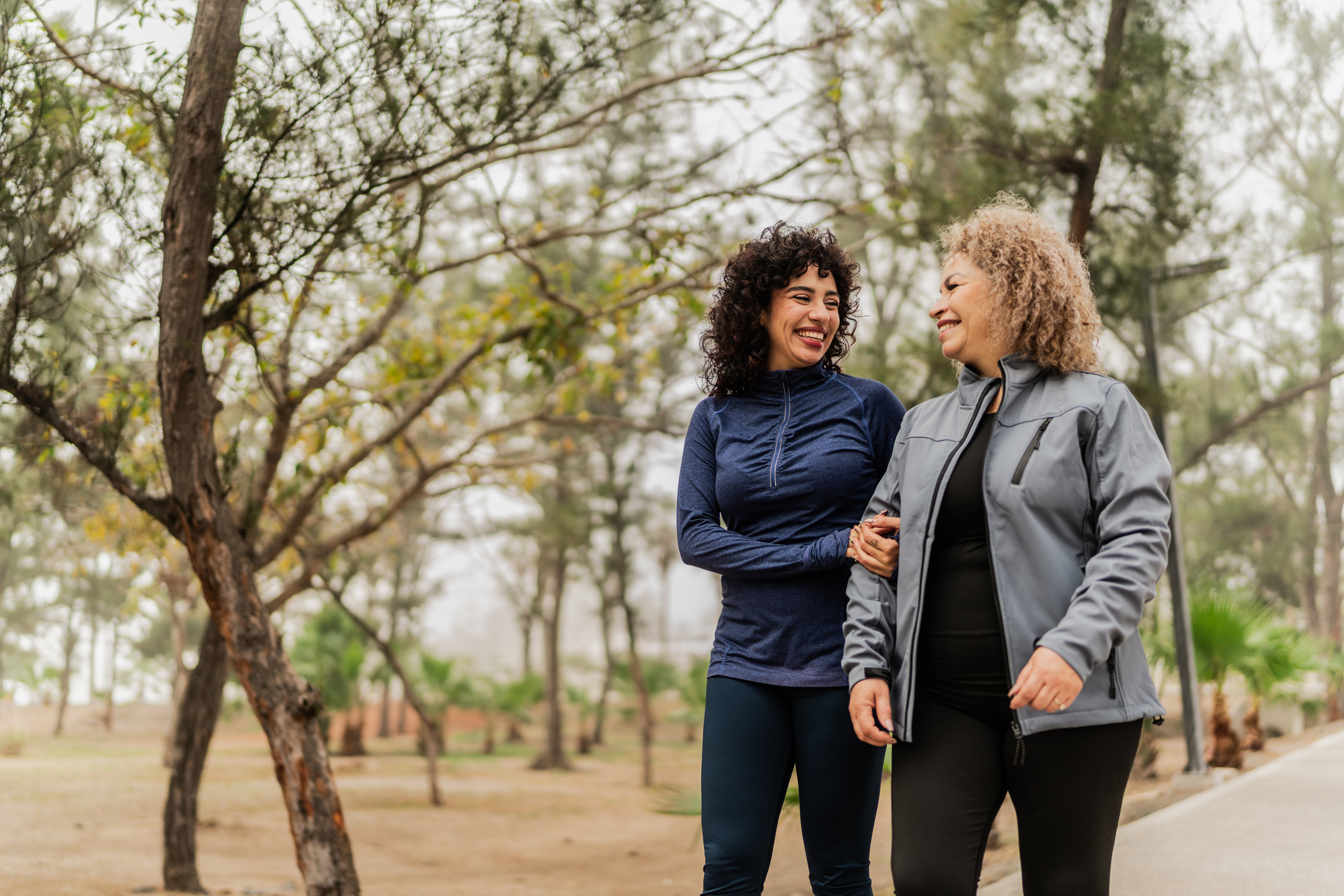 mother and daughter walking in a park